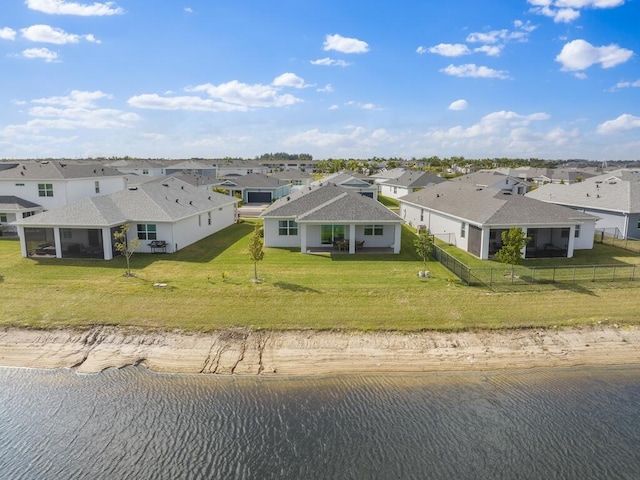 birds eye view of property with a residential view and a water view