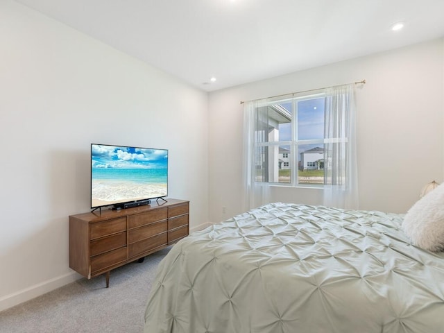 bedroom featuring recessed lighting, light colored carpet, and baseboards