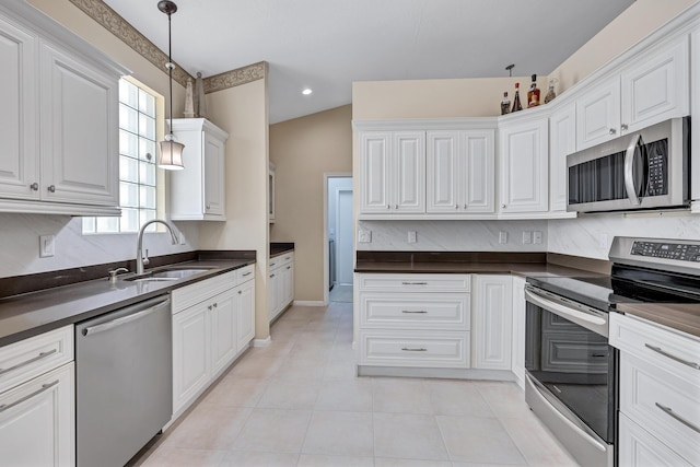 kitchen featuring light tile patterned flooring, sink, white cabinetry, pendant lighting, and stainless steel appliances