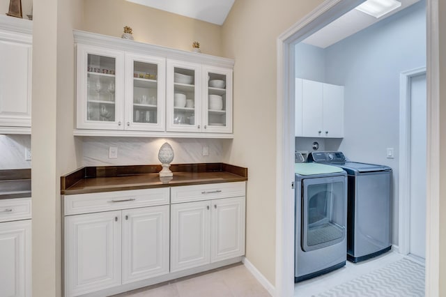 laundry area featuring cabinets and washing machine and dryer