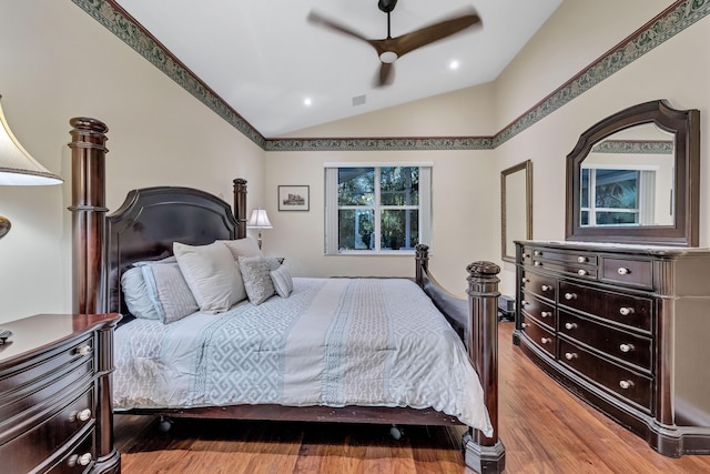 bedroom featuring wood-type flooring, vaulted ceiling, and ceiling fan