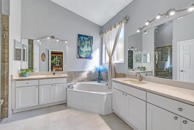 bathroom with vanity, vaulted ceiling, tile patterned floors, and independent shower and bath