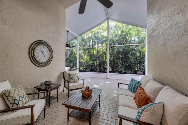 sunroom / solarium featuring lofted ceiling, plenty of natural light, and ceiling fan