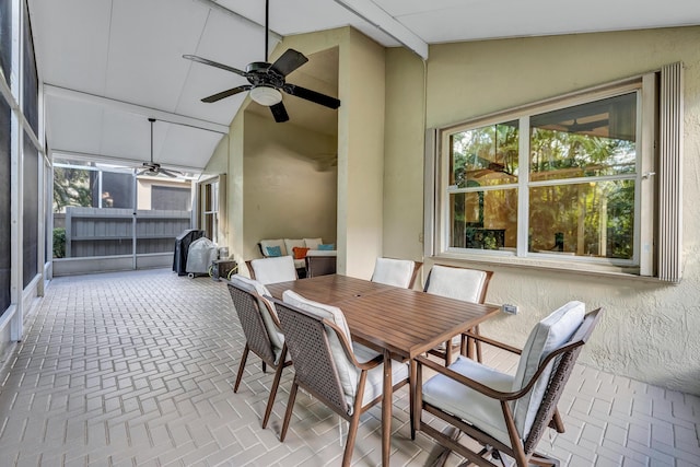 sunroom / solarium featuring ceiling fan and vaulted ceiling