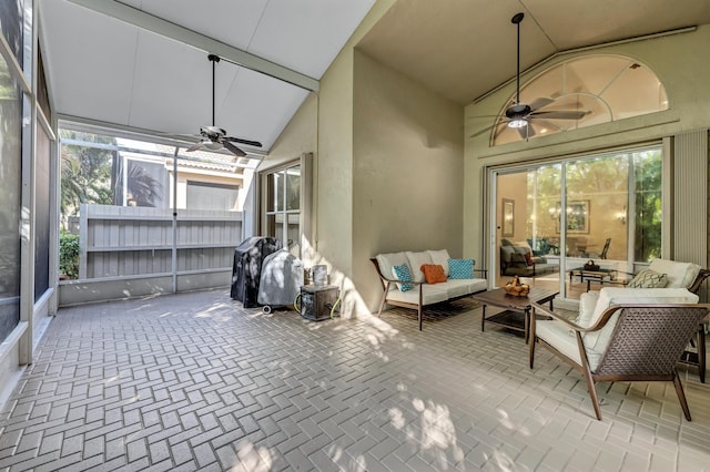 sunroom featuring vaulted ceiling and ceiling fan