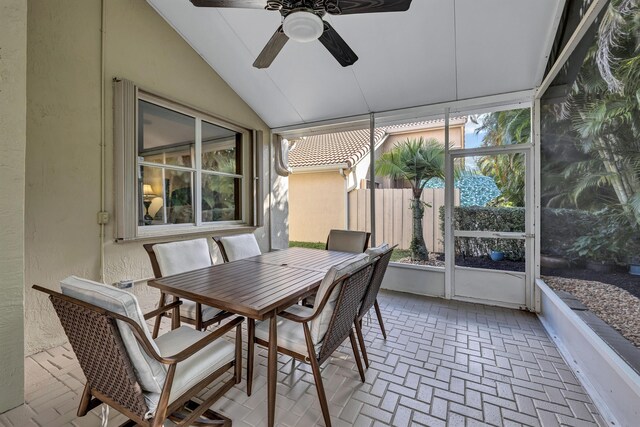 sunroom with lofted ceiling and ceiling fan