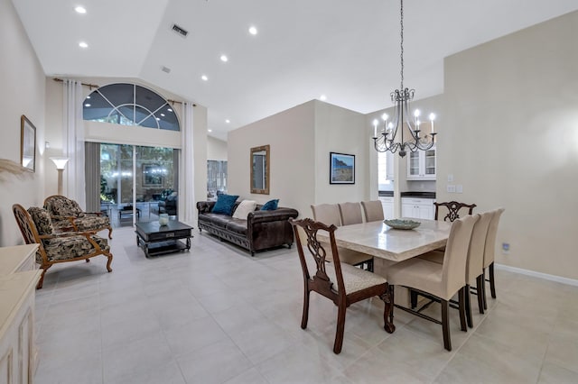 dining room with an inviting chandelier and high vaulted ceiling