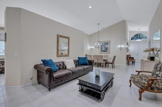 living room with a notable chandelier, high vaulted ceiling, and light tile patterned flooring