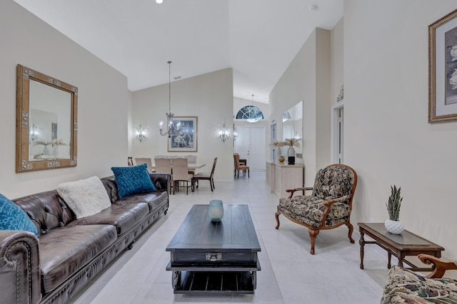 tiled living room with high vaulted ceiling and a chandelier