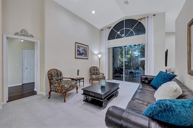 living room featuring high vaulted ceiling and light tile patterned floors