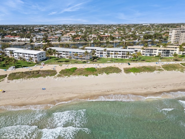 bird's eye view featuring a water view and a beach view