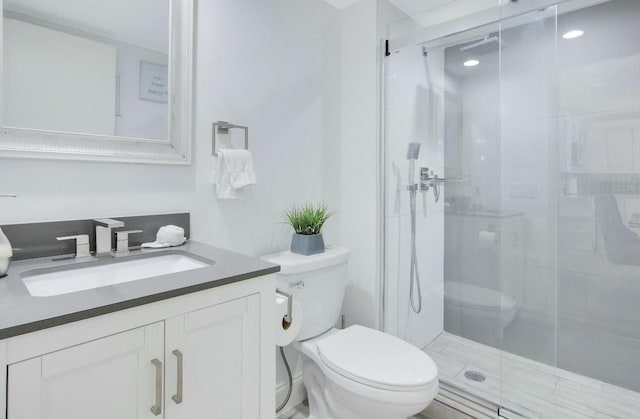 bathroom with vanity, an enclosed shower, and toilet