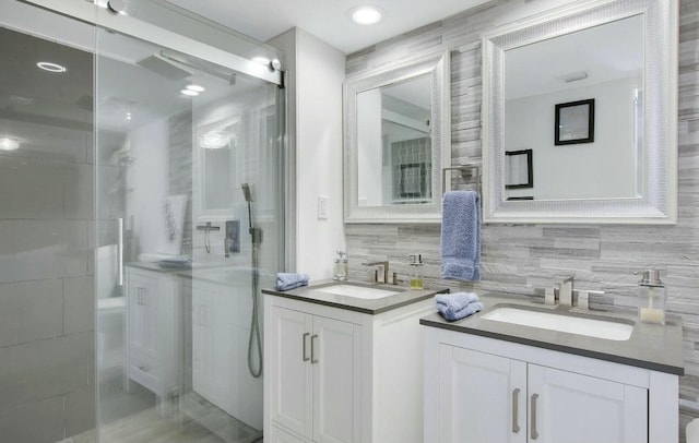 bathroom with tasteful backsplash, vanity, and an enclosed shower