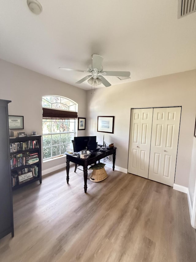 office space with hardwood / wood-style flooring and ceiling fan