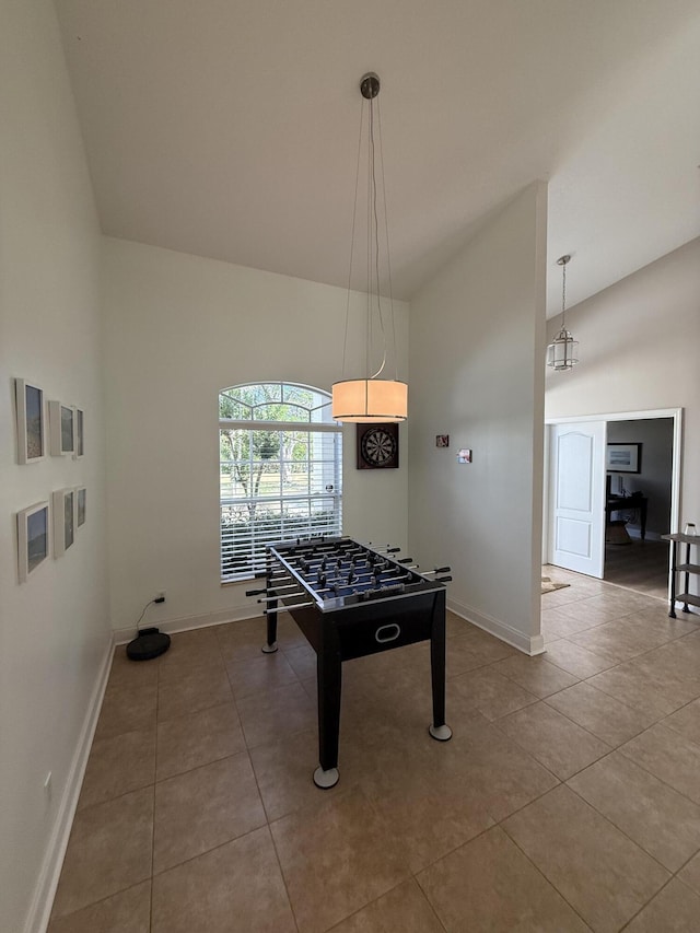 game room featuring tile patterned flooring and high vaulted ceiling