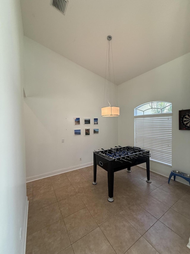 playroom featuring high vaulted ceiling and light tile patterned floors