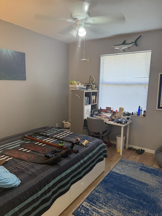 bedroom featuring hardwood / wood-style flooring and ceiling fan