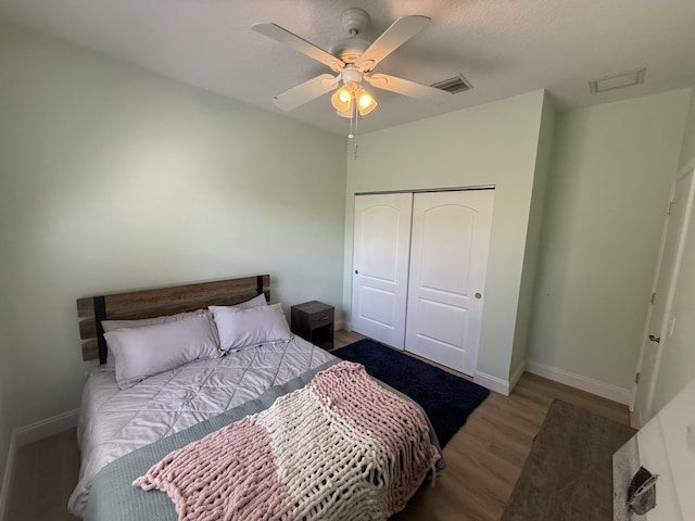 bedroom featuring hardwood / wood-style flooring, a closet, and ceiling fan