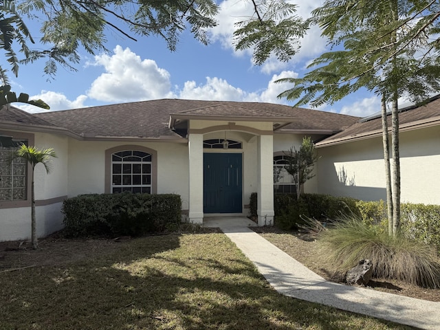 property entrance with a yard