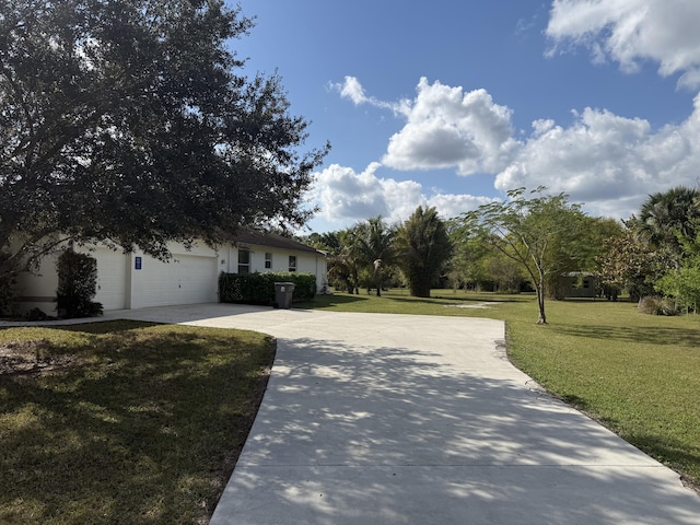 exterior space with a garage and a front lawn