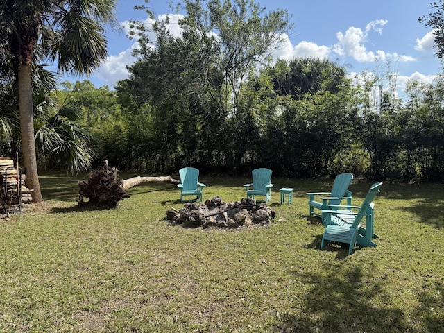 view of yard with an outdoor fire pit