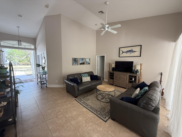 living room with light tile patterned floors, a towering ceiling, and ceiling fan