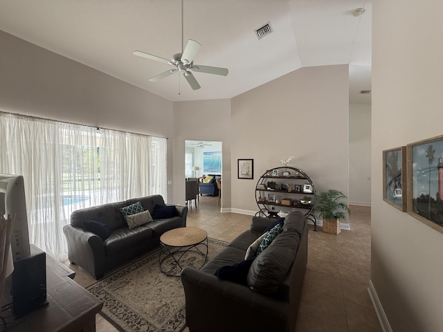 tiled living room with ceiling fan, high vaulted ceiling, and a wealth of natural light