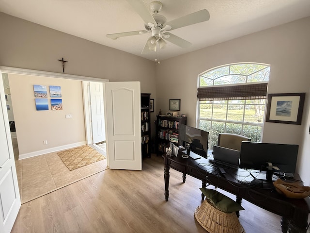 office area with light hardwood / wood-style floors and ceiling fan