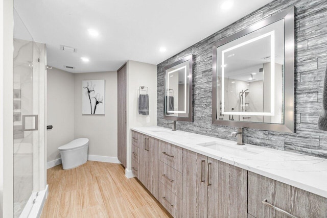 bathroom featuring walk in shower, toilet, vanity, hardwood / wood-style flooring, and decorative backsplash