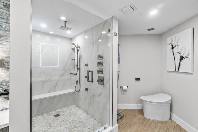 bathroom with hardwood / wood-style flooring, toilet, and an enclosed shower