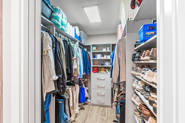 walk in closet featuring light hardwood / wood-style flooring