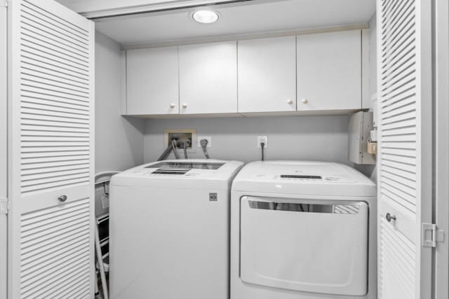 laundry area with cabinets and washing machine and dryer