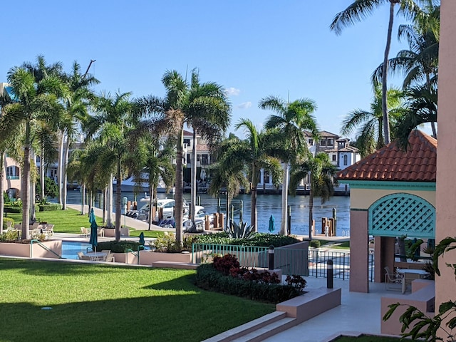 view of home's community featuring a water view and a yard