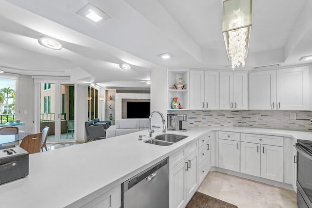 kitchen with white cabinetry, sink, tasteful backsplash, and stainless steel appliances