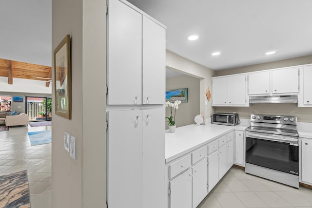 kitchen featuring light tile patterned flooring, beamed ceiling, appliances with stainless steel finishes, and white cabinets