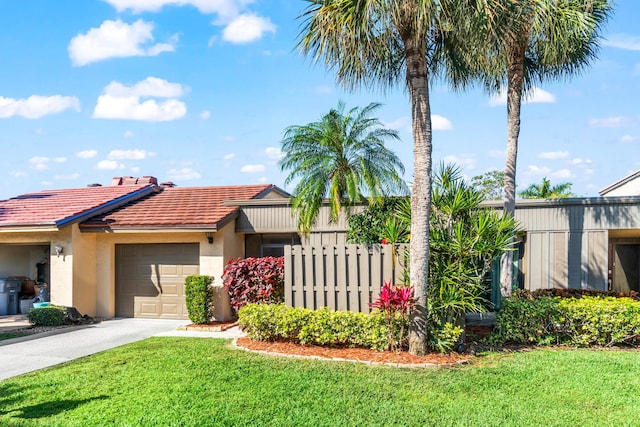 view of front of home with a garage and a front yard