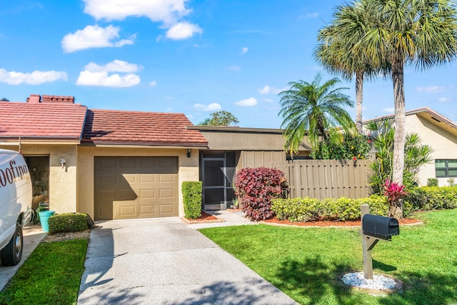 view of front of property with a garage and a front yard