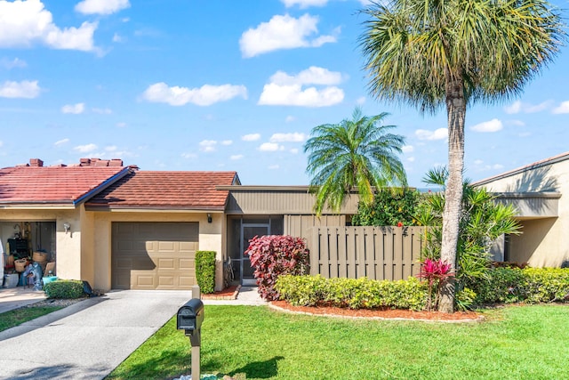 single story home featuring a garage and a front lawn