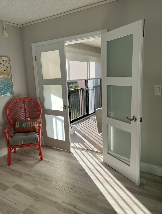 doorway featuring a textured ceiling and light wood-type flooring