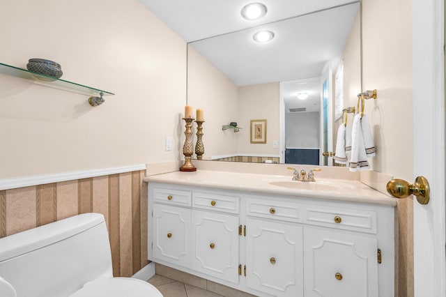 bathroom featuring vanity, tile patterned flooring, and toilet