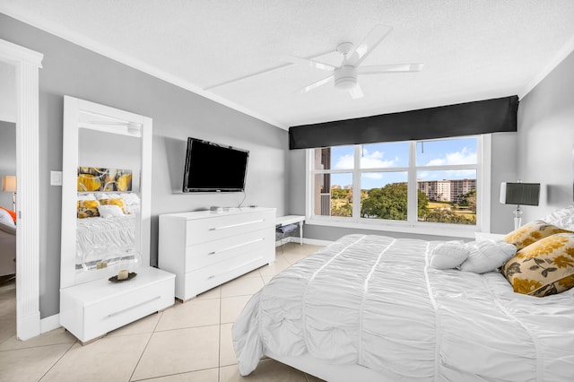 tiled bedroom with ceiling fan and a textured ceiling