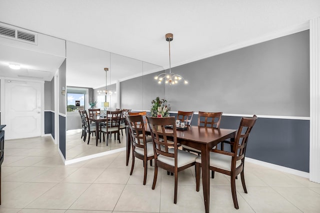 dining area featuring light tile patterned floors, a notable chandelier, and ornamental molding