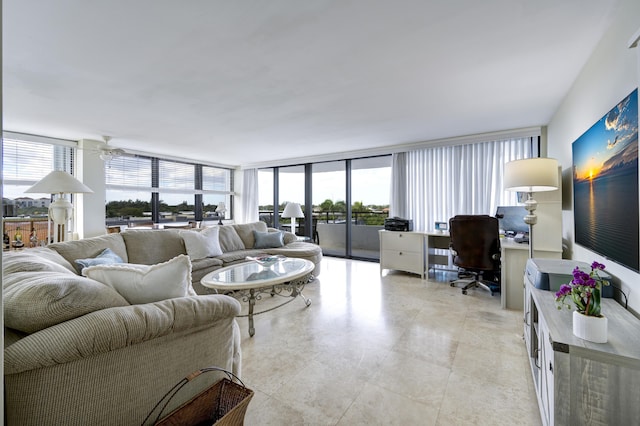 living room featuring expansive windows and ceiling fan