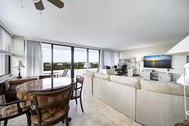 living room featuring expansive windows and ceiling fan