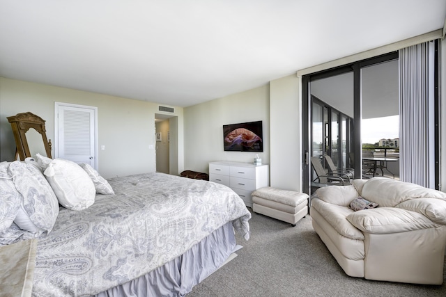 bedroom featuring expansive windows, light colored carpet, and access to exterior