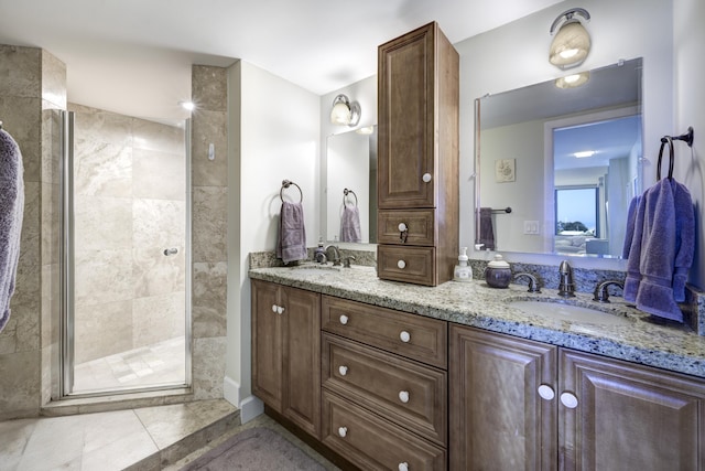 bathroom featuring vanity, tile patterned flooring, and walk in shower