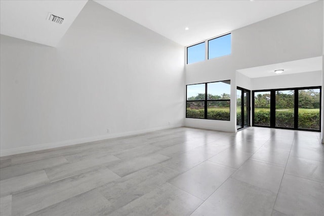 empty room featuring a towering ceiling