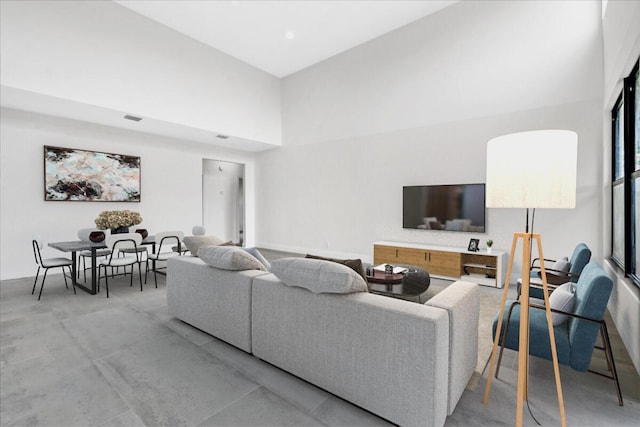 living room featuring a towering ceiling