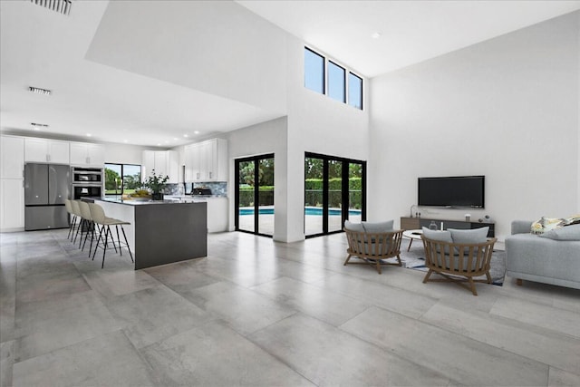 living room with french doors and a high ceiling