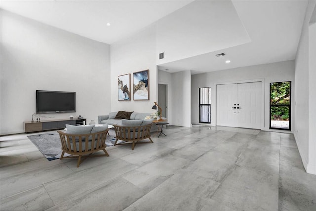 living room featuring a towering ceiling